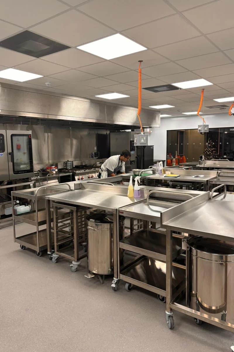 Two chefs preparing food in kitchen
